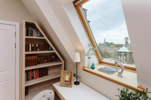 a room with a window with a book shelf at The Scotsman Hotel in Edinburgh