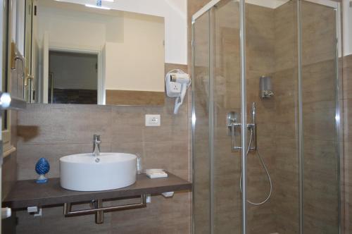 a bathroom with a sink and a shower at BeB L'ALLORO in Pachino