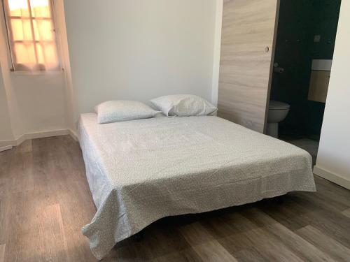 une chambre avec un lit avec une couverture dessus dans l'établissement Double Studios Indépendant, Hyper Centre, WIFI, à Hyères