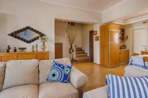 a living room with a white couch with a blue pillow at Gennadi Villa Del Mar in Gennadi