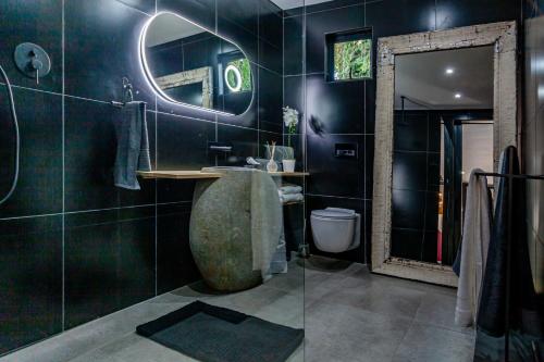 a bathroom with a large sink and a mirror at The Hideaway in Benoni