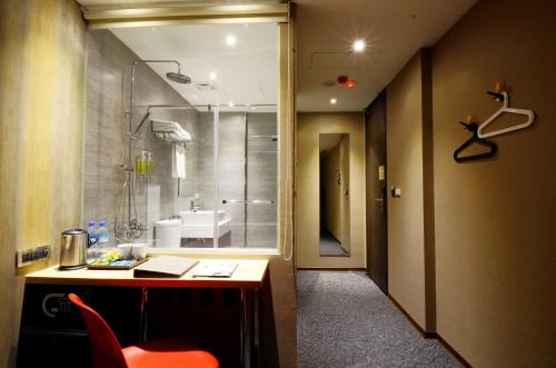 a bathroom with a shower and a desk and a sink at ARK Hotel - Dongmen in Taipei