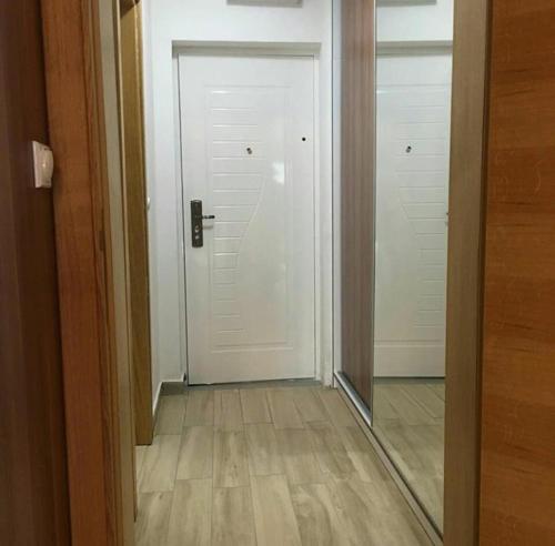 a hallway with a mirror and a white door at Apartman Matija in Herceg-Novi