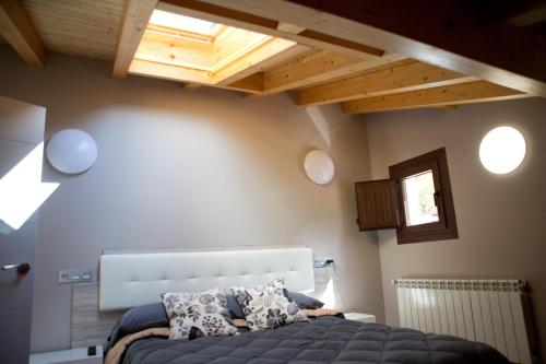 a bedroom with a bed in a room with wooden ceilings at Ca Roxa in Pravia