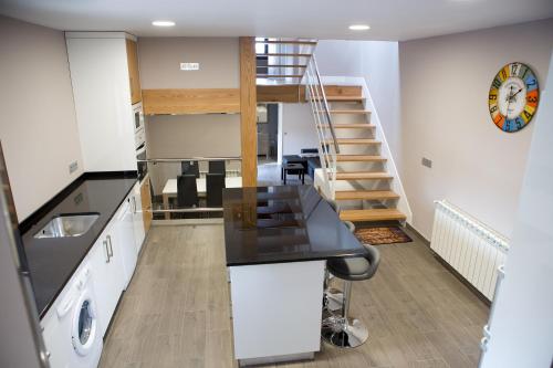 a kitchen with a counter top and a staircase at Ca Roxa in Pravia