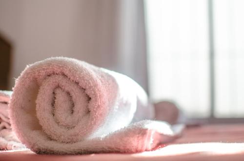 a roll of pink towels sitting on a table at Complejo Granaderos in Mendoza