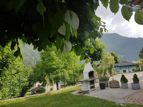 a park with a bench and a monument in the grass at Appartementhaus Zraunig in Flattach
