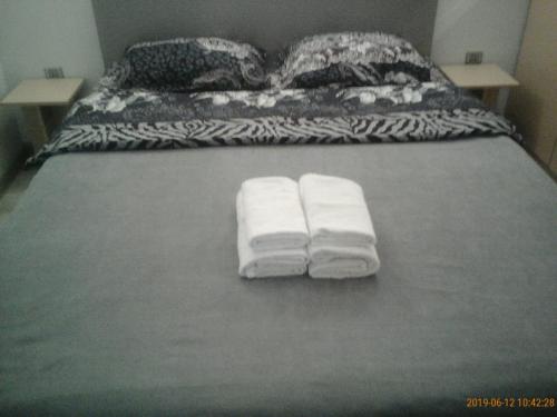 two towels are sitting on a bed in a room at Izmir Apartment in Baku