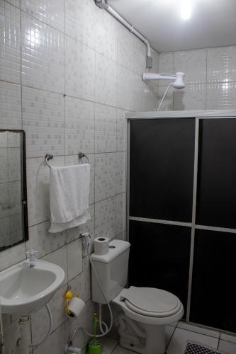 a bathroom with a toilet and a sink at Casa da Esquina Pousada in Recife