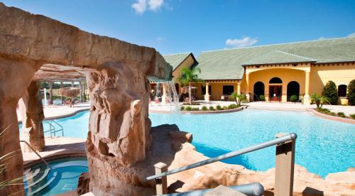 a swimming pool in a resort with a building at DISNEY area Luxurious House-Private Pool in Kissimmee