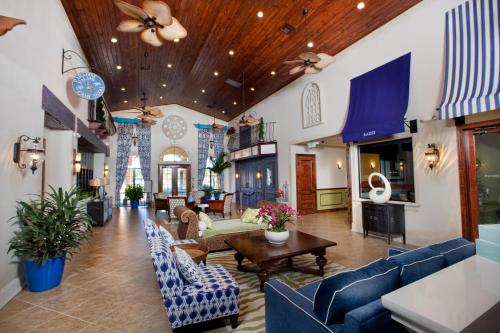 a living room with blue couches and tables at DISNEY area Luxurious House-Private Pool in Kissimmee