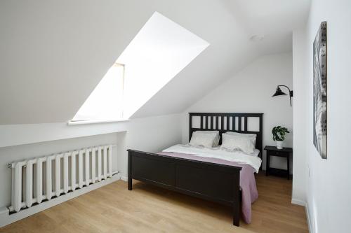 a bedroom with a bed and a window at Baron Arthouse Apartment in Vilnius