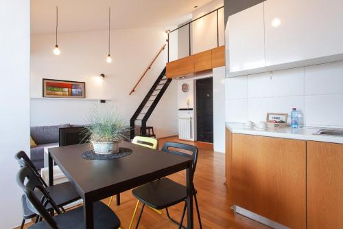 a kitchen and living room with a table and chairs at Urban Serviced Apartments in Skopje