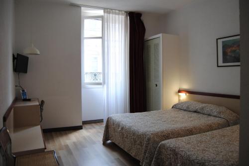 Postel nebo postele na pokoji v ubytování Hôtel Royal