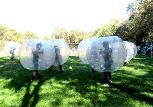a group of people in inflatable bubble balls in a field at Las Montañas de Olmué Resort & Conference Center in Olmué