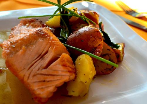 a plate of food with meat and vegetables on a table at Las Montañas de Olmué Resort & Conference Center in Olmué