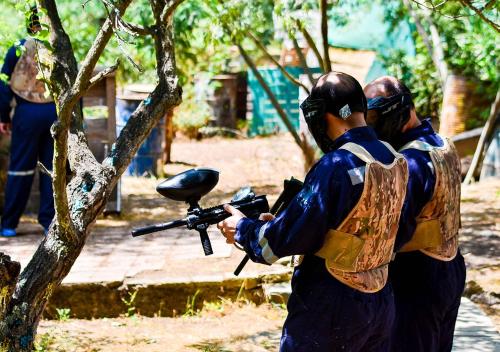 two men are holding a gun in a tree at Las Montañas de Olmué Resort & Conference Center in Olmué