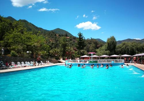 a group of people swimming in a swimming pool at Las Montañas de Olmué Resort & Conference Center in Olmué
