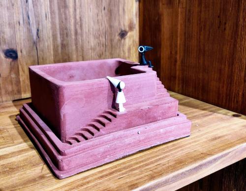 a pink cake sitting on a wooden table at National Forest Park(Yangjiajie ) MINI Inn in Zhangjiajie
