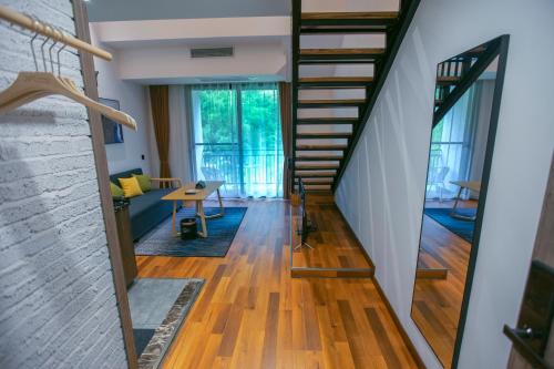 a staircase in a house with wooden floors at National Forest Park(Yangjiajie ) MINI Inn in Zhangjiajie