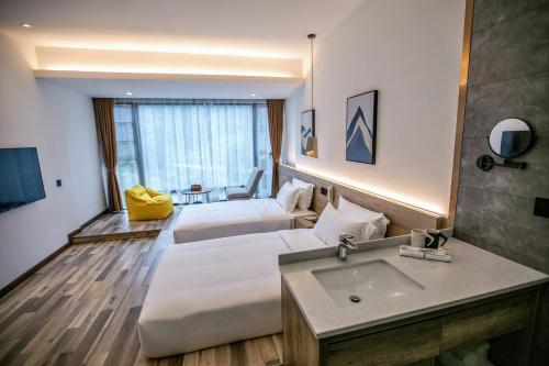 a hotel room with a bed and a sink at National Forest Park(Yangjiajie ) MINI Inn in Zhangjiajie