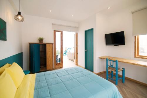 Ένα ή περισσότερα κρεβάτια σε δωμάτιο στο Kauhuhu Casa Hotel