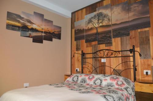 a bedroom with a bed with a wooden wall at Calle Real in San Sebastián de la Gomera