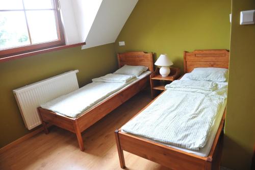 En eller flere senger på et rom på Słoneczne Siedlisko