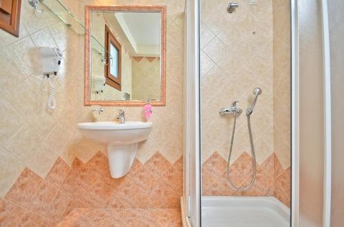a bathroom with a sink and a shower at Anthi Studios in Agia Anna Naxos