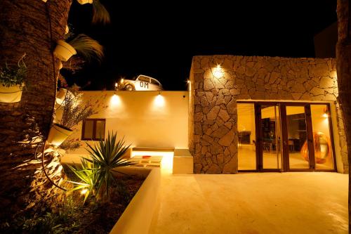 a night view of a building with a door at PAIISE Hotels in Sant Francesc de s'Estany