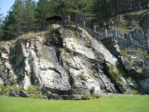 a rocky hill with a fence on top of it at Konačište Osmica in Mokra Gora