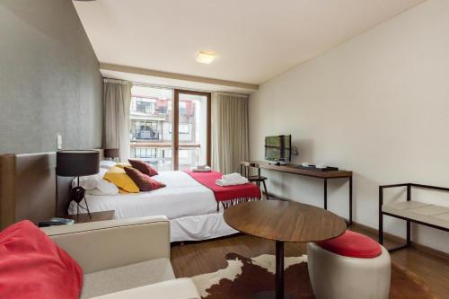 um quarto de hotel com uma cama e uma mesa em PALERMO EVOQUE Thames em Buenos Aires