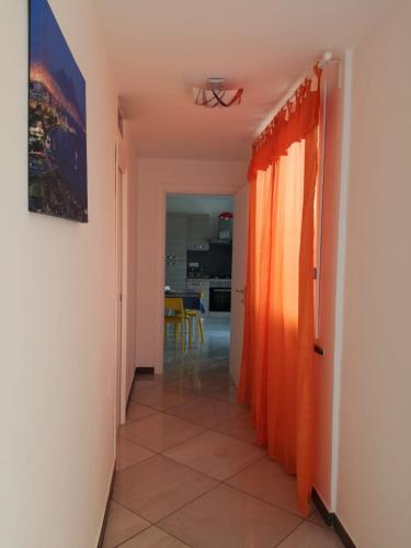 a corridor with orange curtains in a room at Dalla Maestra Lucia in Procida
