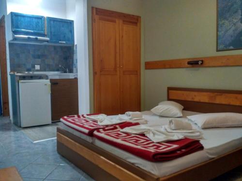 a kitchen with a bed with towels on it at Hotel Livithra in Paralía Skotínis