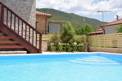 a swimming pool in front of a house at Elafos Spa Hotel in Elliniko