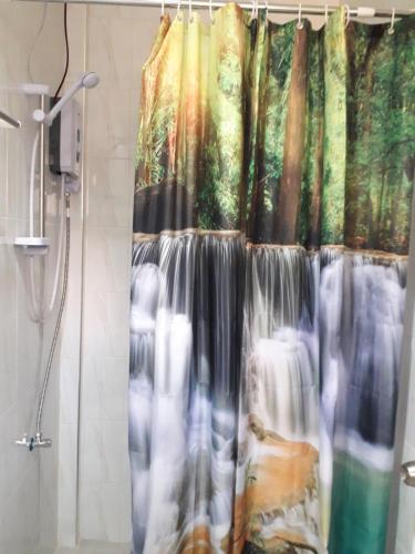 a shower curtain in a bathroom with a shower at Gal's Guesthouse in Siquijor