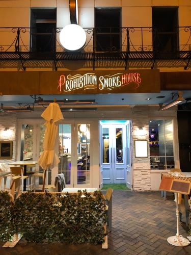 a restaurant with an umbrella in front of a building at The Burlington Luxury Octagon Apartment in Dunedin