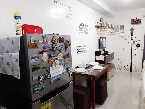 a room with a refrigerator and a table in it at A Cozy fully furnished PRIVATE ROOM IN CONDOMINIUM unit. in Cebu City