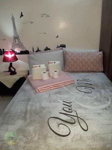 a bedroom with a bed with a lamp and a table with towels at A Cozy fully furnished PRIVATE ROOM IN CONDOMINIUM unit. in Cebu City