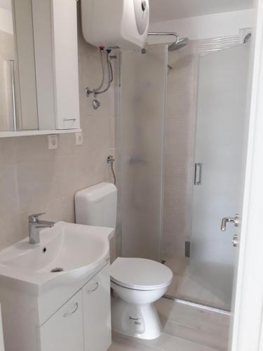 a bathroom with a toilet and a sink and a shower at Apartment Star Danica*** in Šibenik