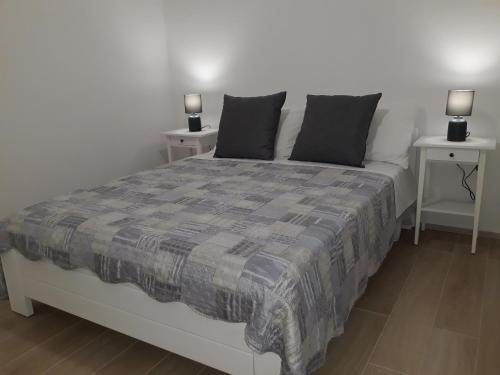 a bedroom with a bed with two night stands at Apartment Star Danica*** in Šibenik