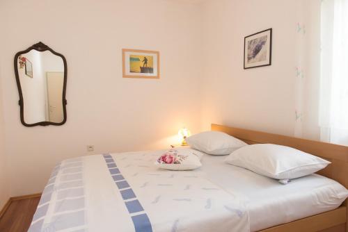 a bedroom with a bed with a mirror on the wall at Apartments Vodice Olga Matic in Vodice