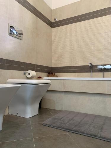 a bathroom with a tub and a toilet and a sink at ''A casa di Lele'' in Avola