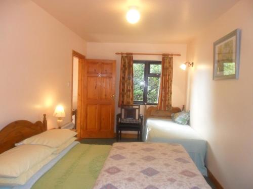 a bedroom with two beds and a window at Glen House Room Only Accommodation in Youghal