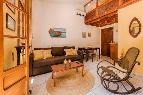 a living room with a couch and a table at The Old Symi in Symi