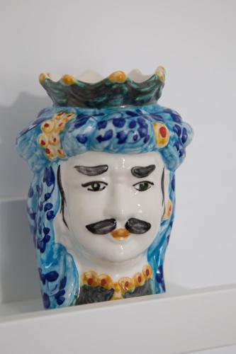 a statue of a mask with a crown on its head at AmaSi Affittacamere in Siracusa