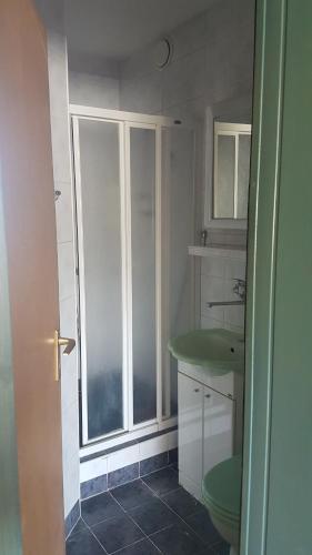 a bathroom with a green sink and a window at Studio Andrus in Władysławowo
