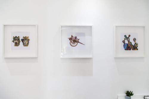 four framed pictures on a white wall at AmaSi Affittacamere in Siracusa