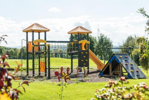 a park with a playground with a slide at Hotel & Golfrestaurant Gut Wissmannshof in Staufenberg