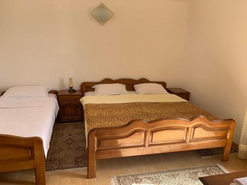 a bedroom with two beds and a nightstand and sidx sidx sidx sidx at Apartments Zvicer - Milica in Budva